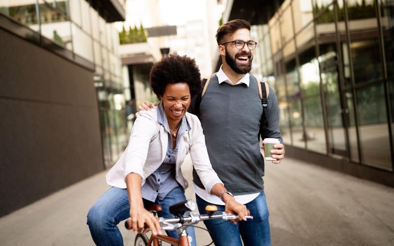 a man walking and a woman riding a bicycle