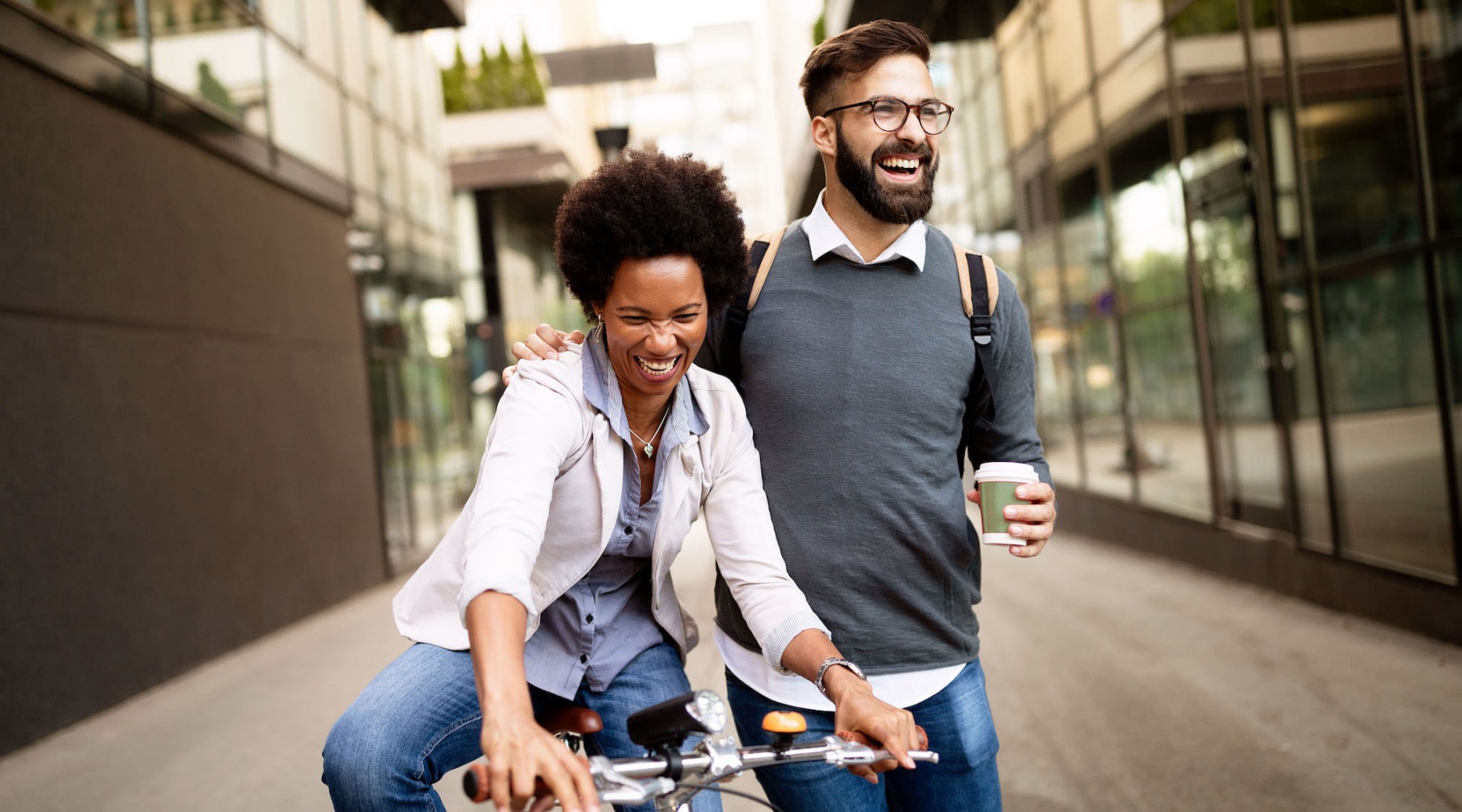 a man walking and a woman riding a bike on the sreeet