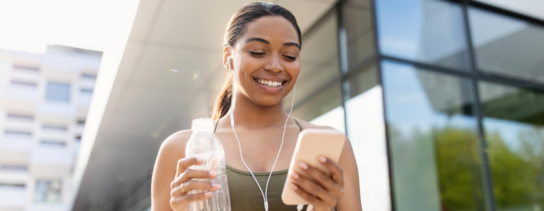 a woman holding a bottle of water